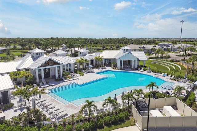 community pool featuring a patio area, a residential view, a gazebo, and fence