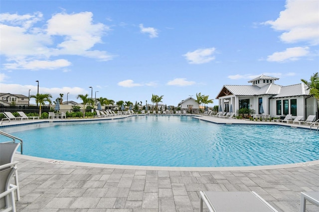 community pool featuring a patio area and fence