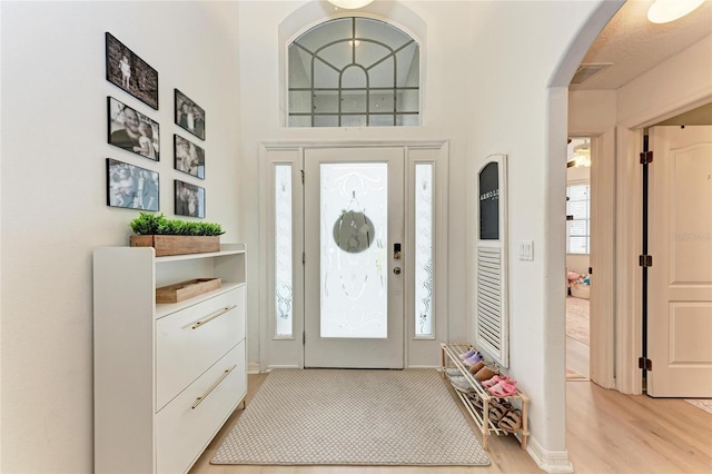 foyer with light wood-style floors and visible vents