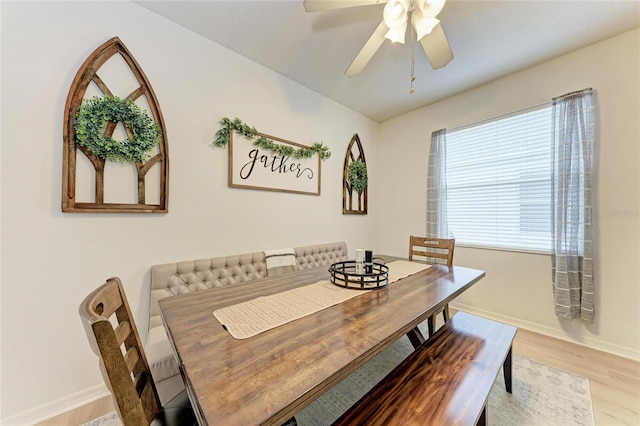 dining room with a ceiling fan, baseboards, and wood finished floors