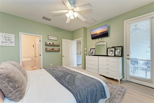 bedroom with light wood-style flooring, multiple windows, visible vents, and access to outside