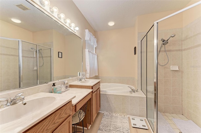 full bathroom with a stall shower, visible vents, vanity, and a bath