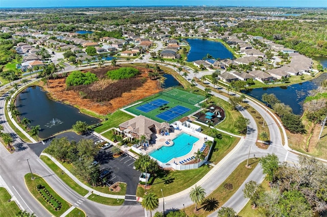 birds eye view of property with a water view and a residential view