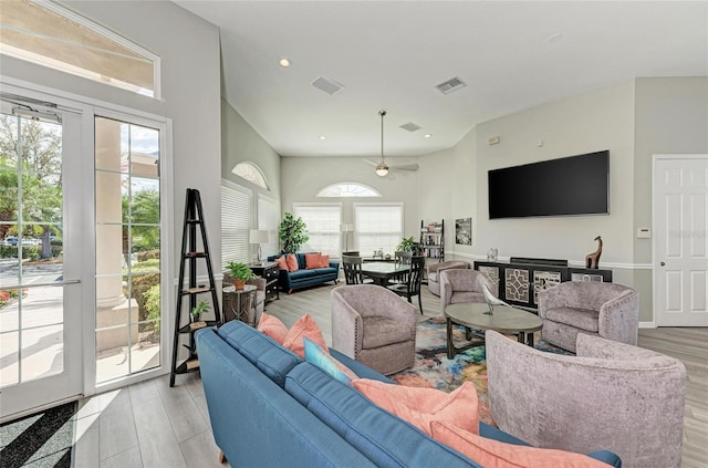 living area with light wood-style flooring, visible vents, and recessed lighting