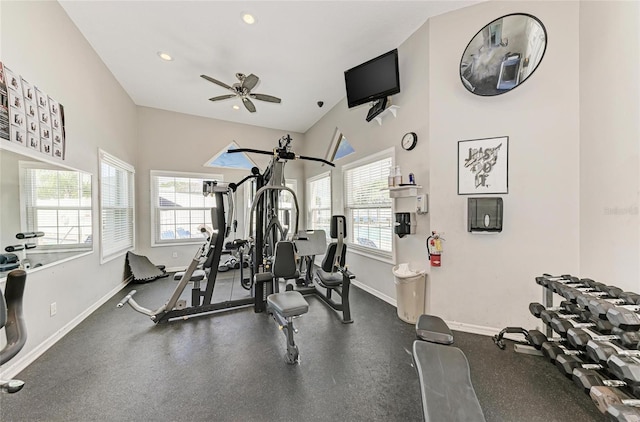 workout area with ceiling fan, a healthy amount of sunlight, recessed lighting, and baseboards