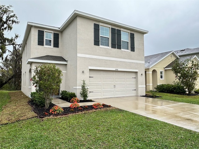 traditional home with a garage, a front lawn, concrete driveway, and stucco siding