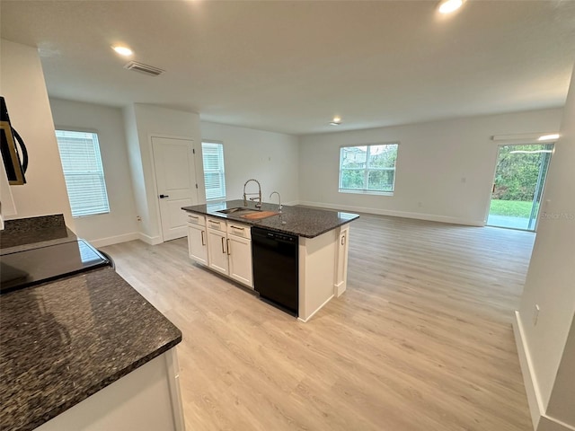 kitchen featuring a sink, visible vents, white cabinets, black dishwasher, and light wood-type flooring