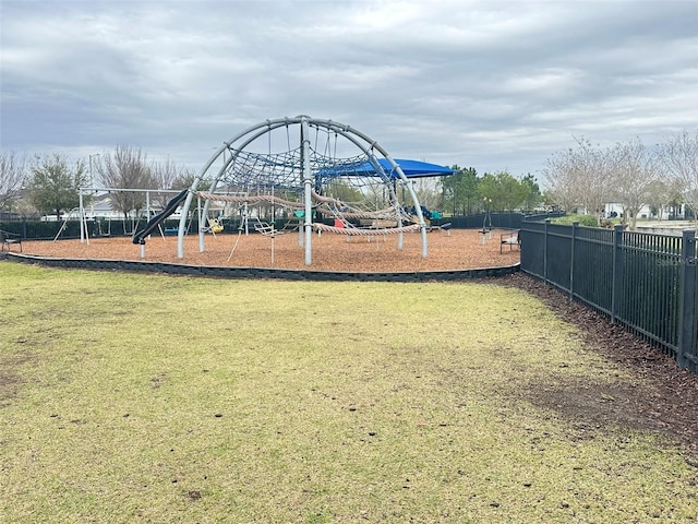 community playground with a yard and fence