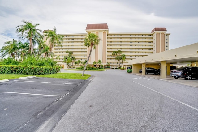 view of property with covered and uncovered parking