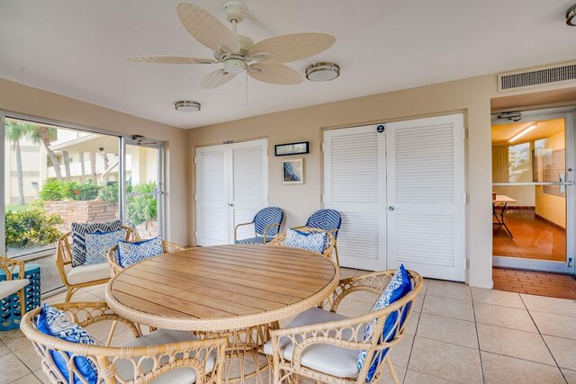 dining space featuring light tile patterned floors, ceiling fan, and visible vents