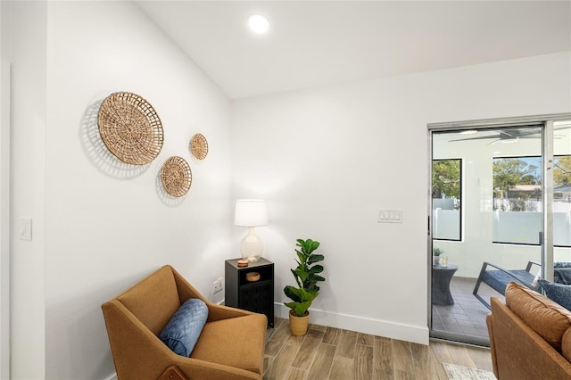 sitting room featuring baseboards, wood finished floors, and recessed lighting