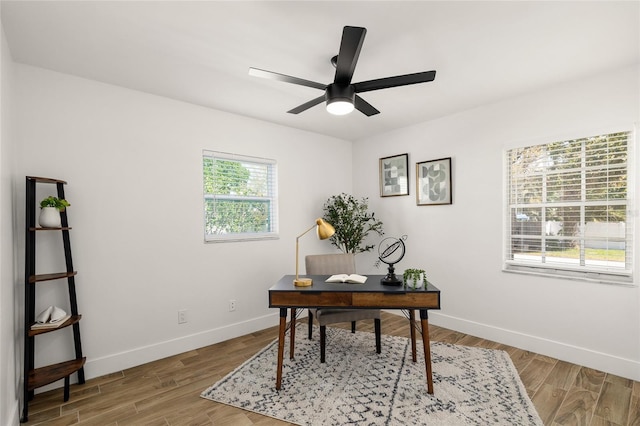 office with baseboards, ceiling fan, and light wood finished floors