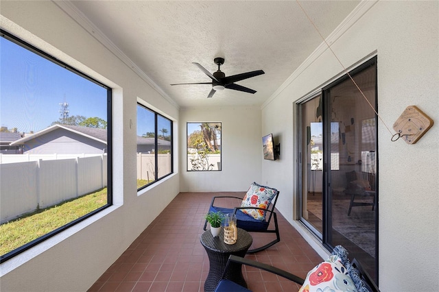 sunroom featuring a ceiling fan