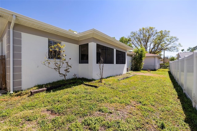 exterior space featuring a yard and fence