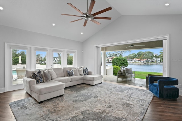 living room featuring a ceiling fan, wood finished floors, a water view, french doors, and high vaulted ceiling