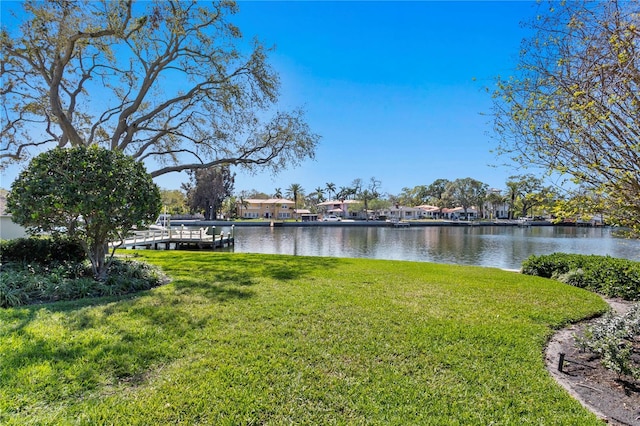 view of yard featuring a residential view and a water view