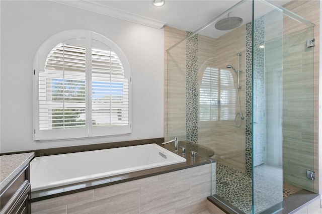 full bathroom with a stall shower, crown molding, and a bath