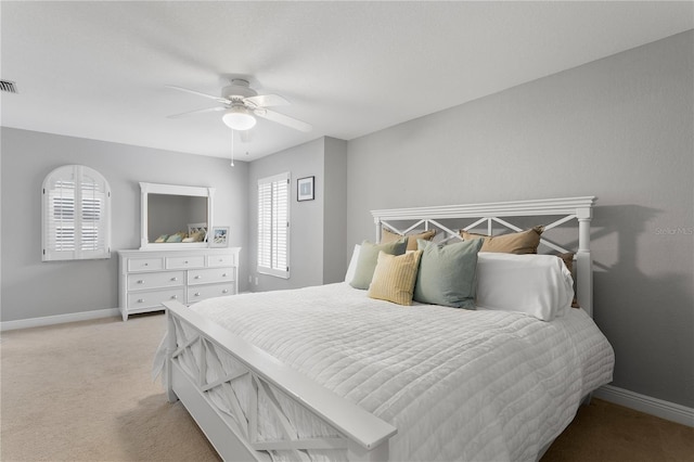 bedroom featuring light carpet, ceiling fan, visible vents, and baseboards