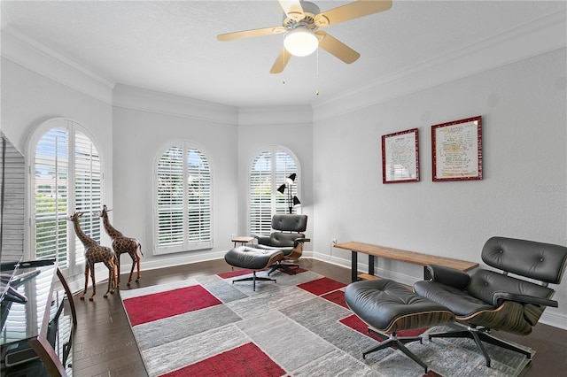 sitting room featuring hardwood / wood-style flooring, ceiling fan, baseboards, and crown molding