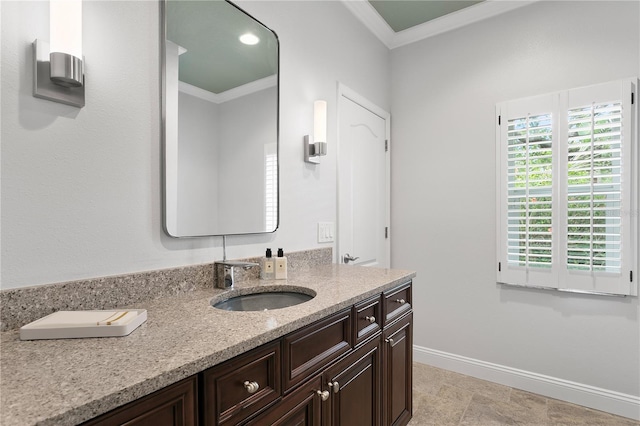 bathroom featuring ornamental molding, vanity, and baseboards