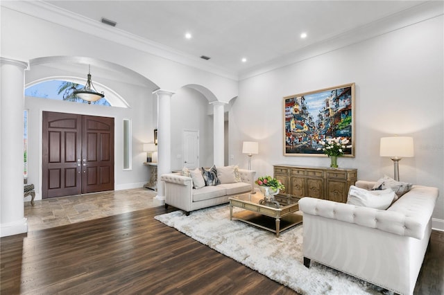 living room featuring ornamental molding, visible vents, ornate columns, and wood finished floors