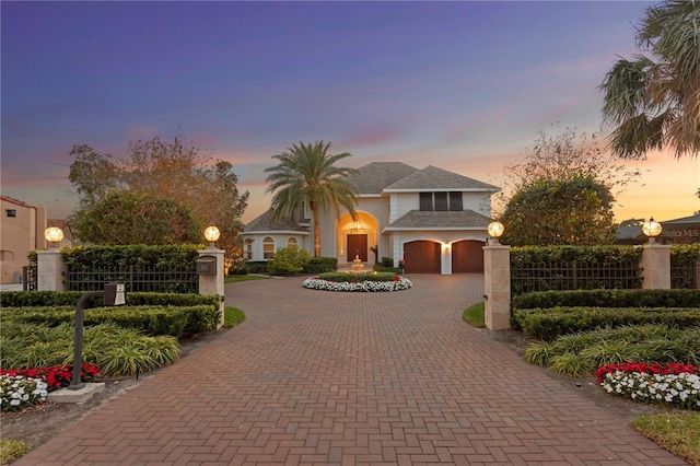 view of front of property with a fenced front yard and decorative driveway