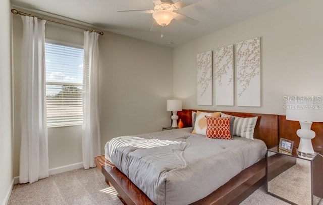 carpeted bedroom featuring ceiling fan and baseboards