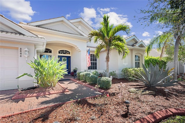 view of front of home featuring stucco siding and an attached garage