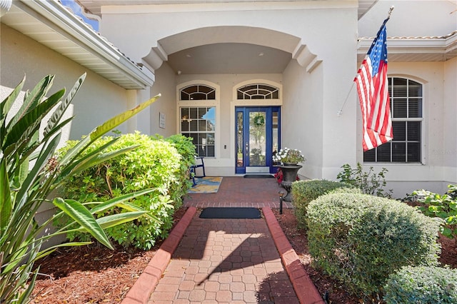 view of exterior entry featuring stucco siding