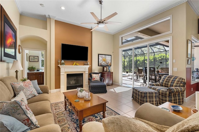 living room with a glass covered fireplace, tile patterned floors, crown molding, and a sunroom