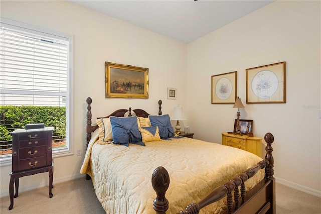 bedroom featuring baseboards and light carpet