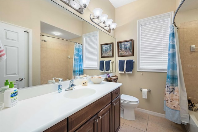 bathroom with vanity, baseboards, tile patterned flooring, shower / bath combination with curtain, and toilet