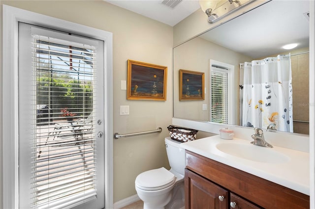 full bath with a wealth of natural light, visible vents, toilet, and vanity