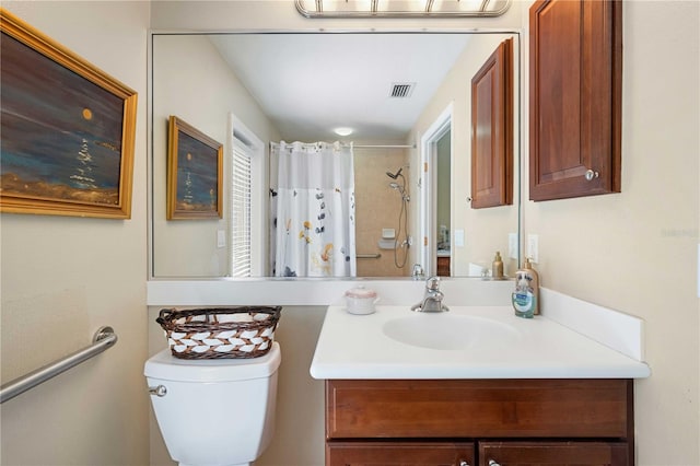 bathroom featuring visible vents, toilet, vanity, and a shower with curtain