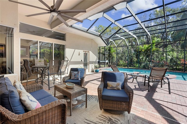 view of patio / terrace featuring glass enclosure, a ceiling fan, an outdoor pool, and an outdoor hangout area