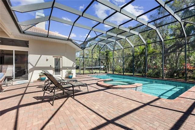 view of pool featuring a patio, a pool with connected hot tub, and a lanai