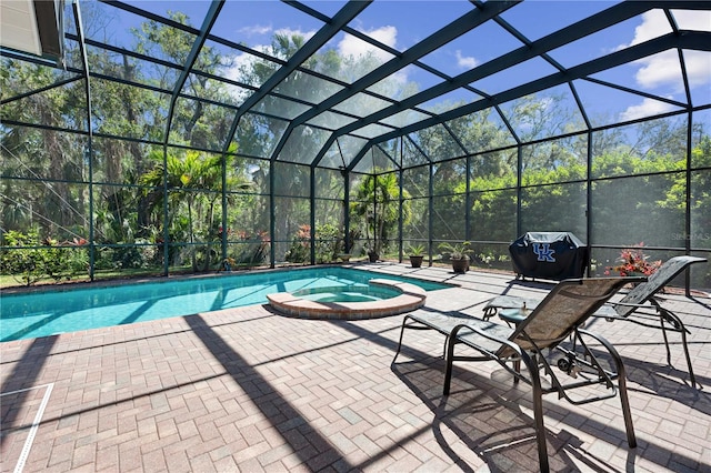 view of pool featuring glass enclosure, a patio, a grill, and a pool with connected hot tub