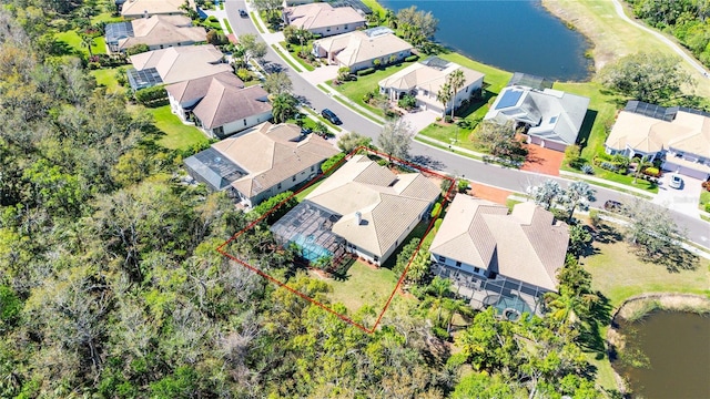 birds eye view of property with a residential view and a water view