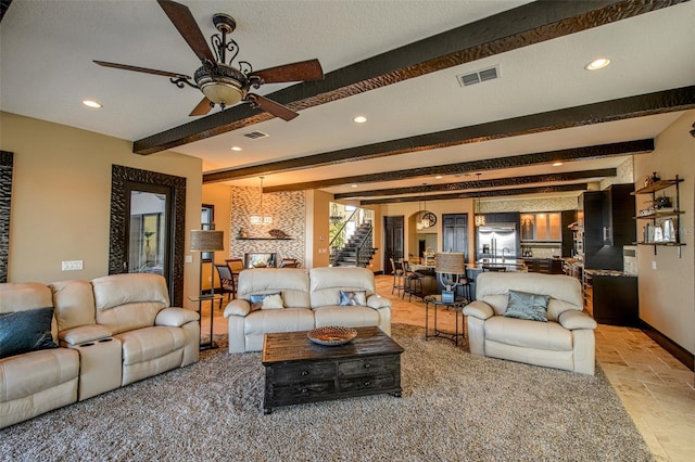 living room with visible vents, beamed ceiling, stone tile floors, recessed lighting, and stairway