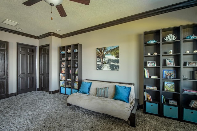 sitting room with baseboards, a textured ceiling, crown molding, and carpet