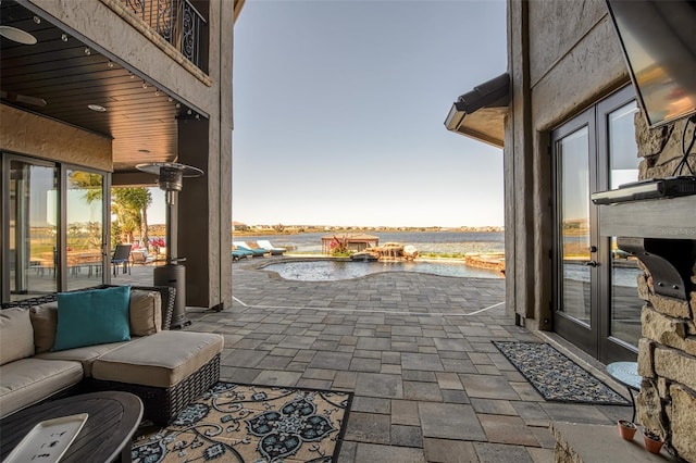 view of patio / terrace featuring an outdoor hangout area and a water view