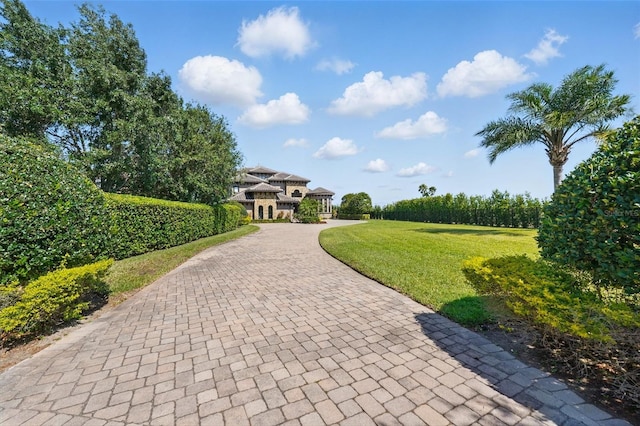 surrounding community with a gazebo, a yard, and decorative driveway