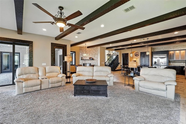 living area with a ceiling fan, beam ceiling, visible vents, and recessed lighting