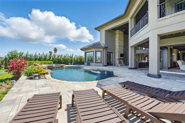 view of pool with a patio and a pool with connected hot tub