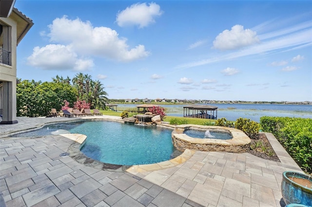 view of swimming pool with a pool with connected hot tub, a patio, and a water view