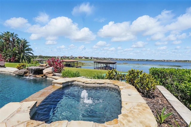 pool with an in ground hot tub and a water view