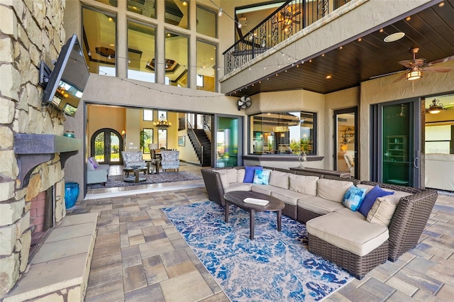 exterior space featuring ceiling fan, an outdoor hangout area, a balcony, and stairs