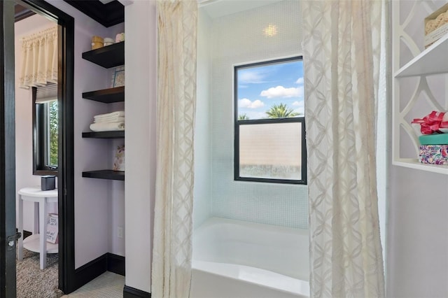 bathroom with shower / bath combination with curtain