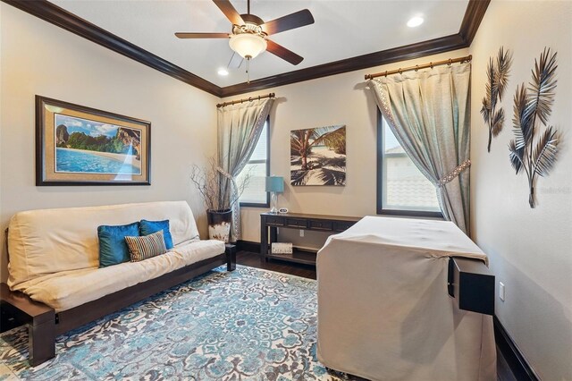 office area featuring ceiling fan, baseboards, wood finished floors, and ornamental molding