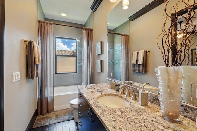 bathroom featuring baseboards, wood finished floors, toilet, and vanity